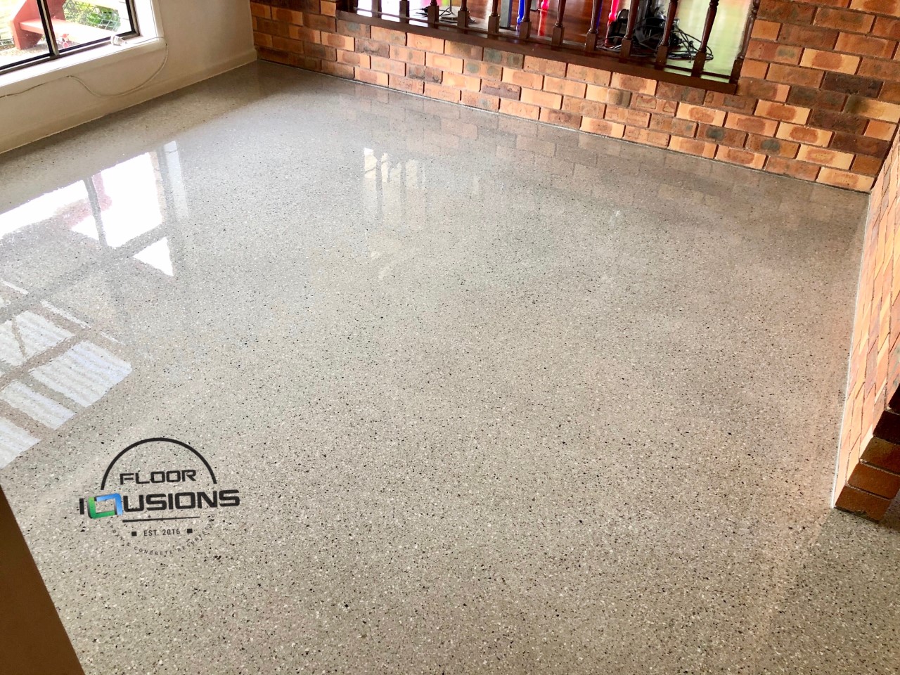 Several coats of the Ezypoly high-build polyurethane was used to create a smooth, high-gloss polished concrete look in a home.