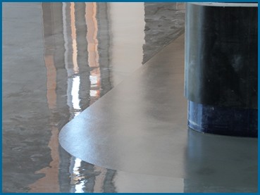 A commercial epoxy floor in a bar with a smooth, glossy section next to a non-slip section.