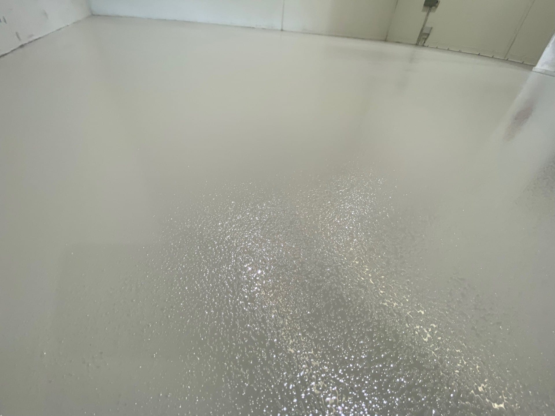 A low angle shot of the vibrant signal red non-slip epoxy floor showing the aggressive non-slip texture required in the abattoir.