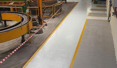 Resin Grip used for non-slip pathways and yellow line marking in a factory environment. 