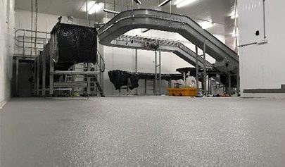 A close-up, low-angle shot of a Resin Rock system in a commercial kitchen showing the non-slip finish.