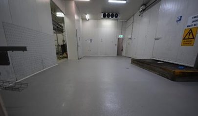 A Resin Rock system with non-slip finish installed in a commercial kitchen cold room.