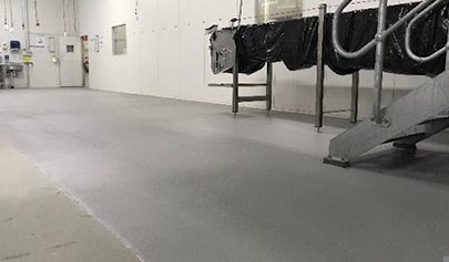 A Resin Rock system applied in and around a set of stairs in a food processing facility.