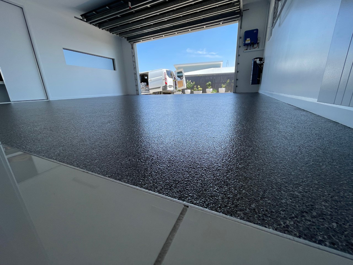 A garage epoxy flooring system from Real World Epoxies in the form of a beautiful, black flake floor.
