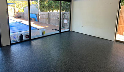 The Resin Granite system installed in a residential living room that looks over an outdoor pool.