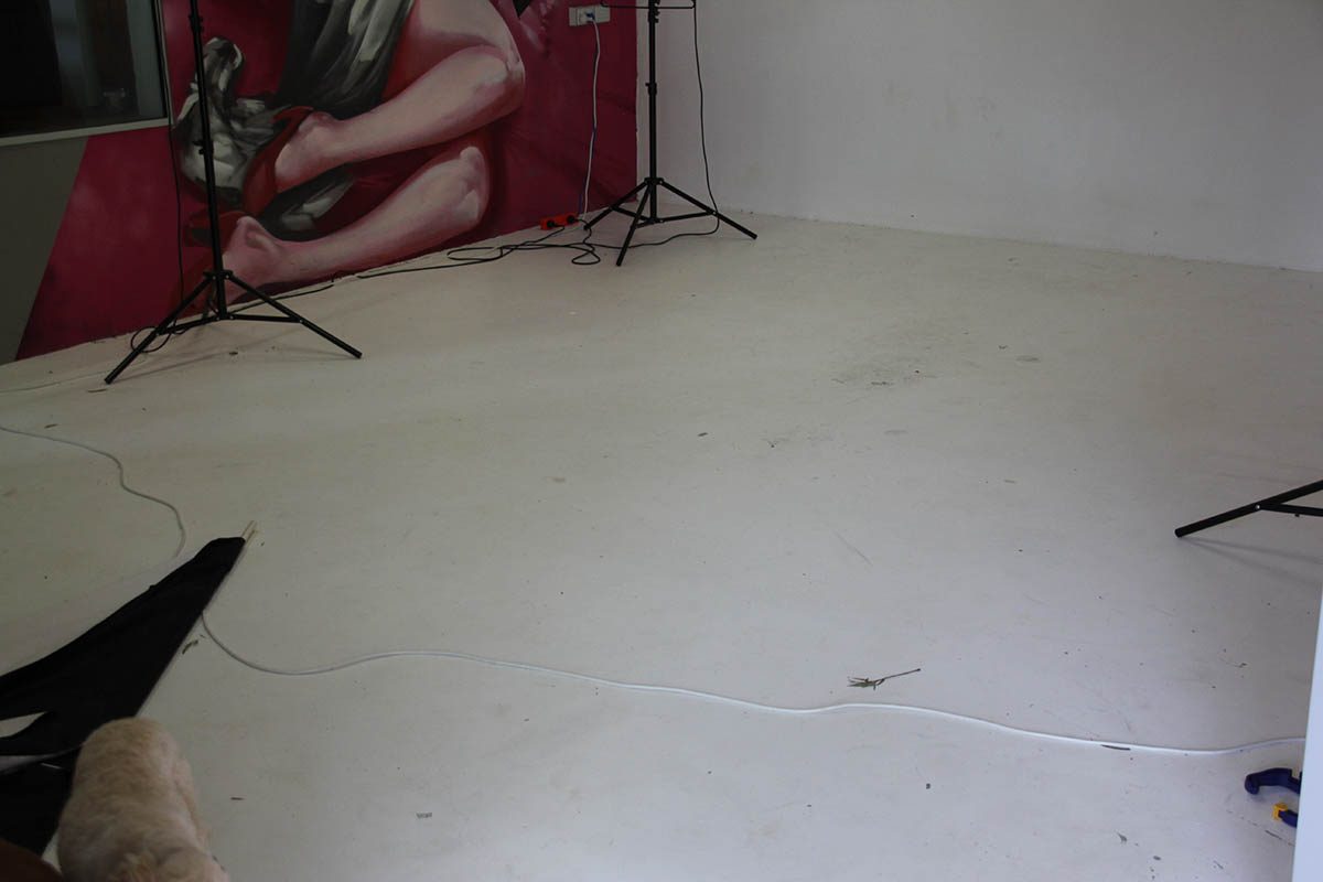 A photo taken before the project of the dull and dirty original white floor that was affecting photo quality in the studio.