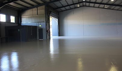 The Resin Guard system installed in a new yet empty warehouse with the large front roller door open.