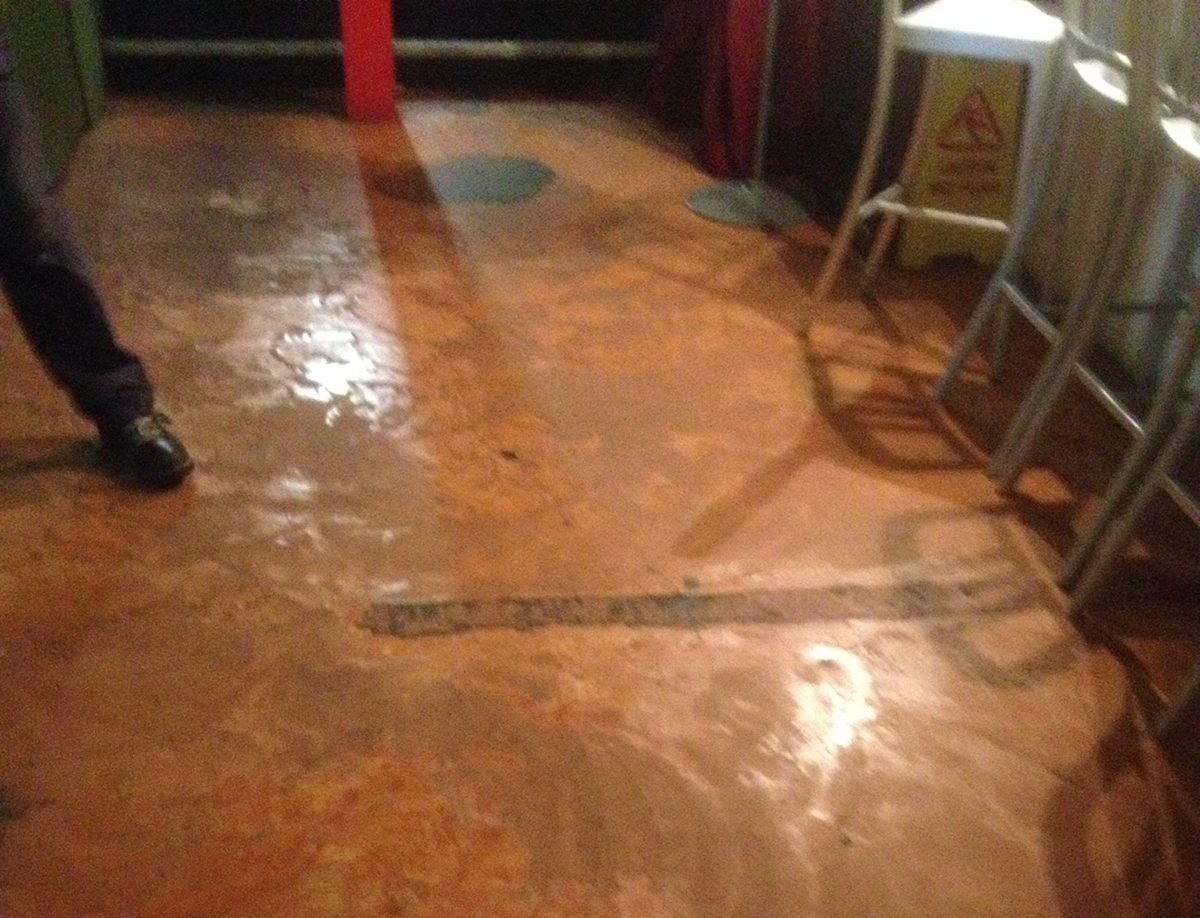 The cafe entrance, which had an old floor in place with an unusual orange colour and extensive wear and tear.