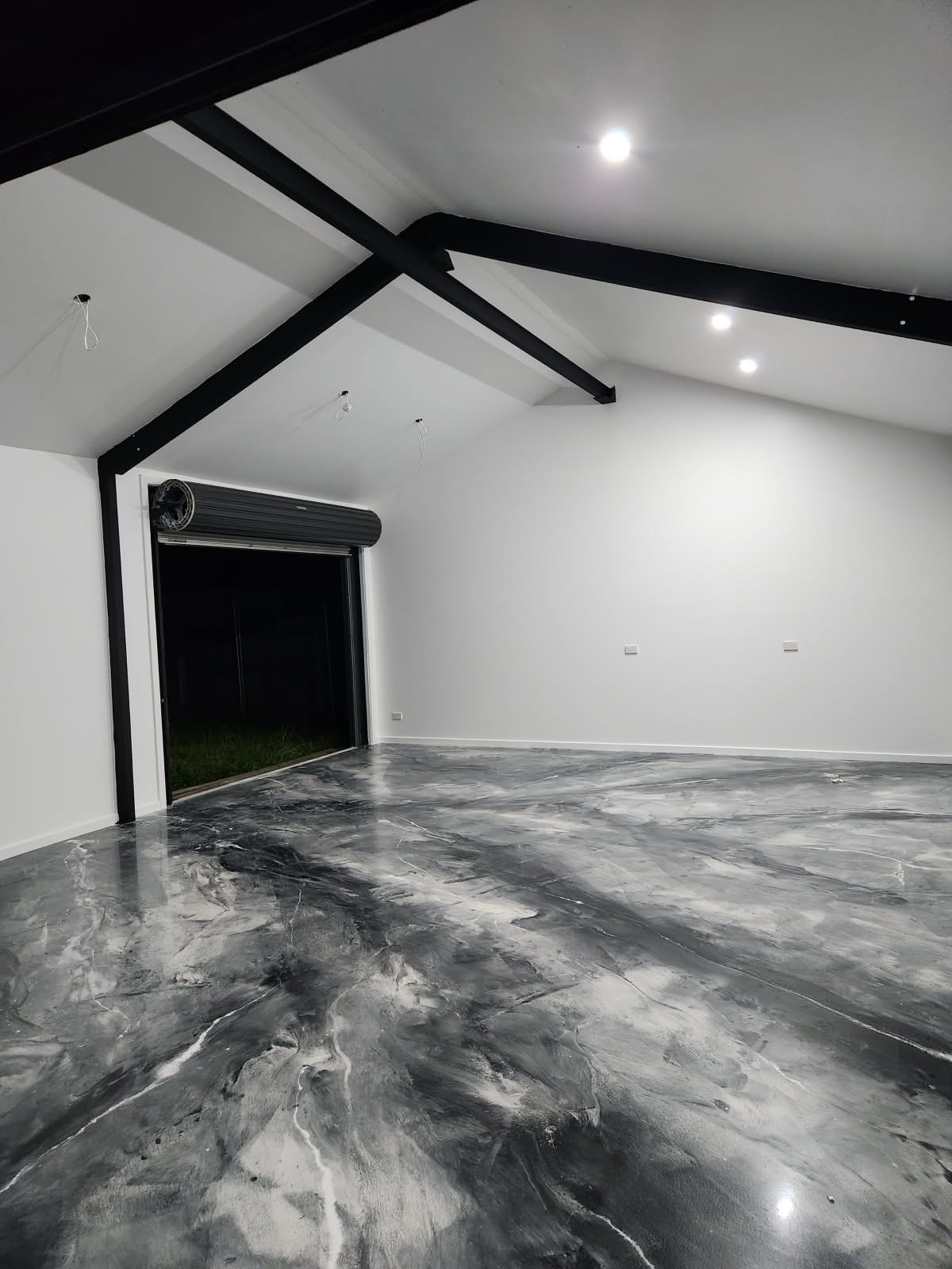 A photo taken from the back of the cafe looking towards the entrance, showing the clean, modern look the new silver metallic epoxy floor provided.