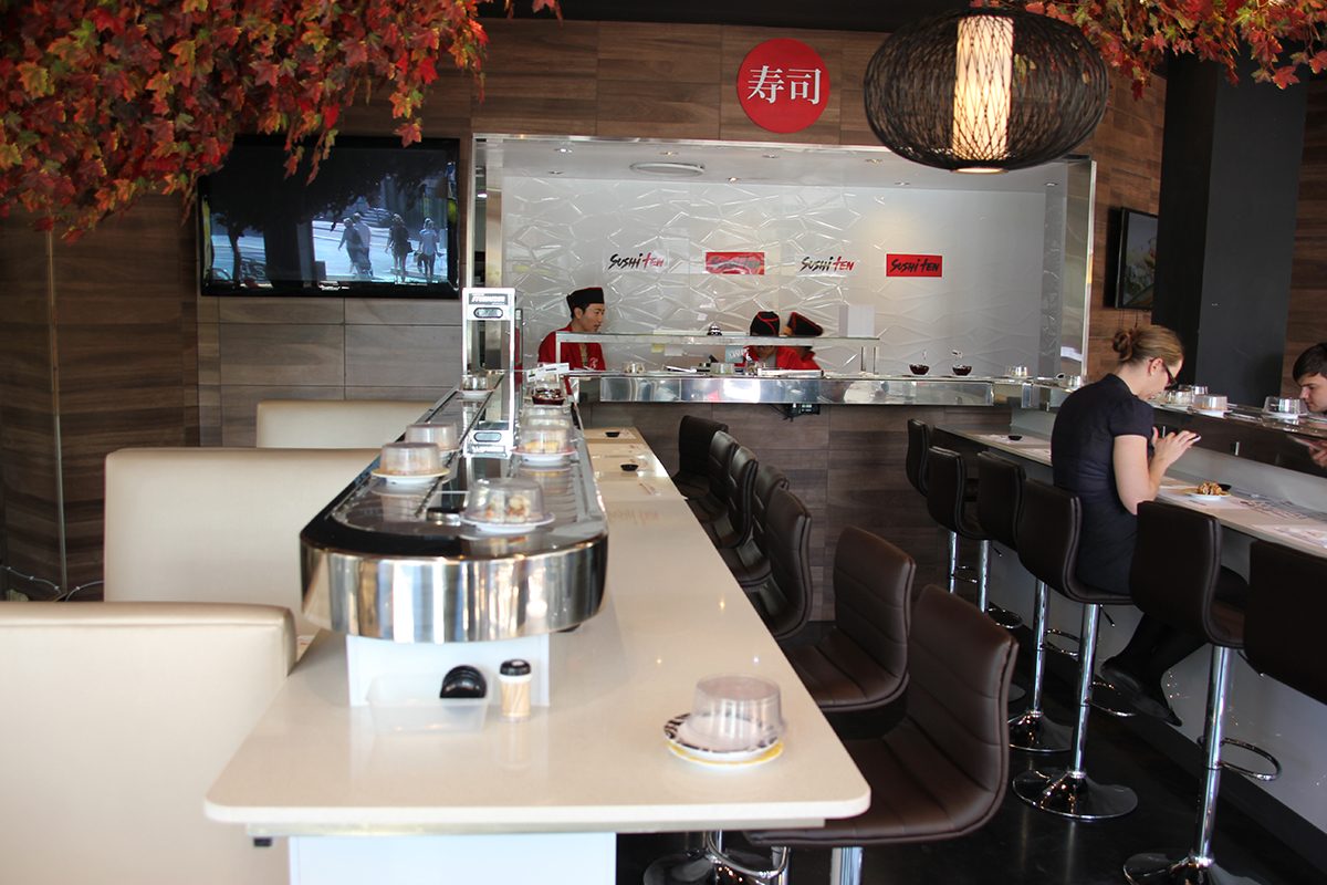 A photo taken from the restaurant entrance showing the new metallic epoxy floor stretching up to the kitchen and service area.