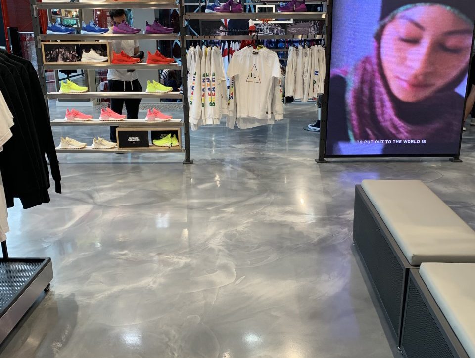 A close-up photo of the decorative epoxy floor, showing the glossy, concrete-like finish that complemented the furnishings and displays beautifully.