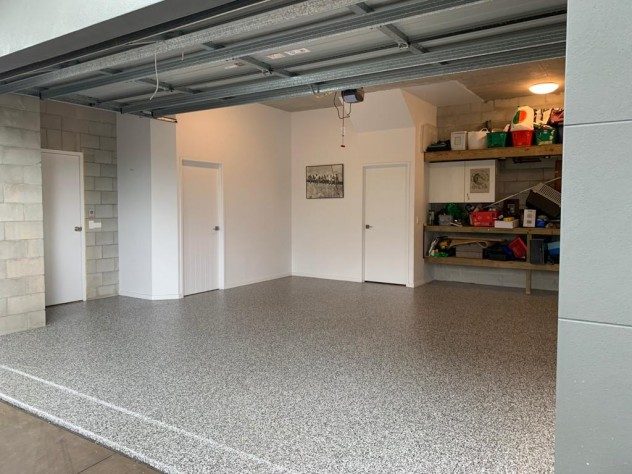 A front shot of a home, looking into the garage that has a new Resin Vinyl floor installed.