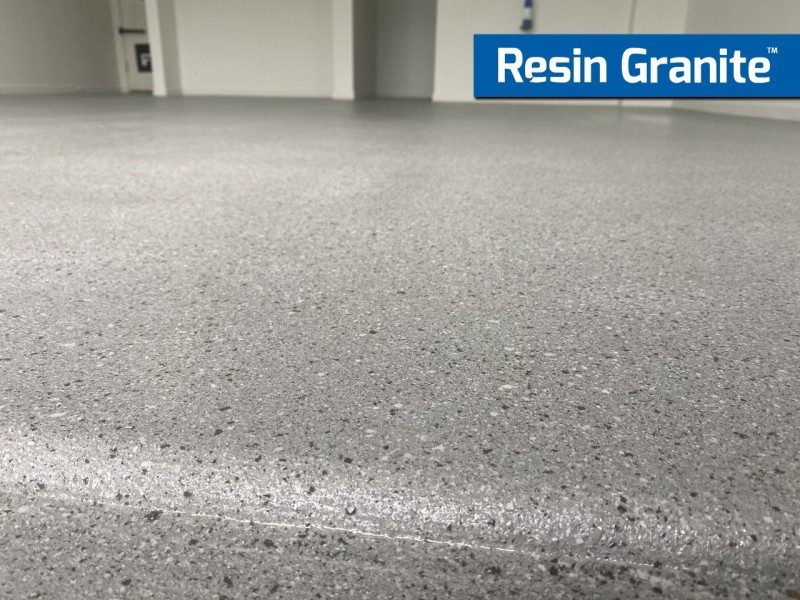A low-angle photo of a Resin Granite floor in a garage showing the colour and finish of the flake system.