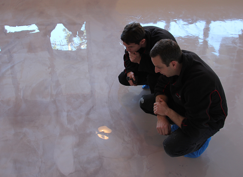 Inspecting the application of a metallic epoxy floor topcoat.