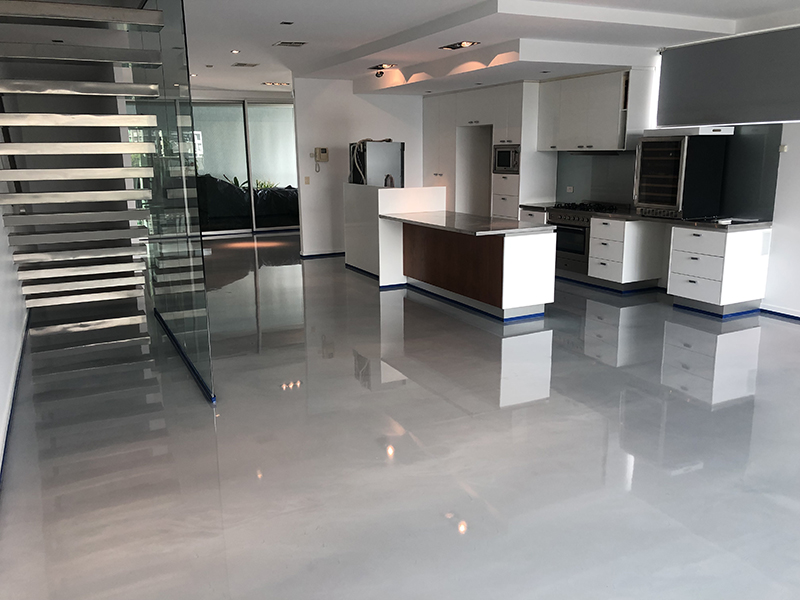 Metallic epoxy floor with marble pattern in kitchen.